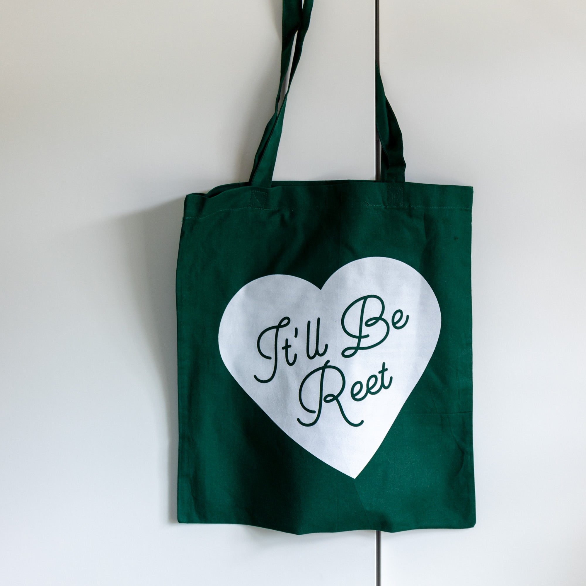green tote shoulder bag with heart design and printed it'll be reet slogan in script font