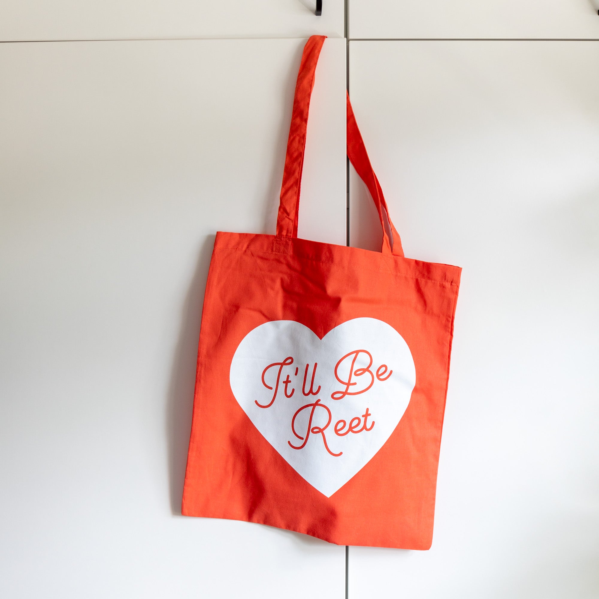 bright shopping tote bag with it'll be reet slogan printed on a white heart